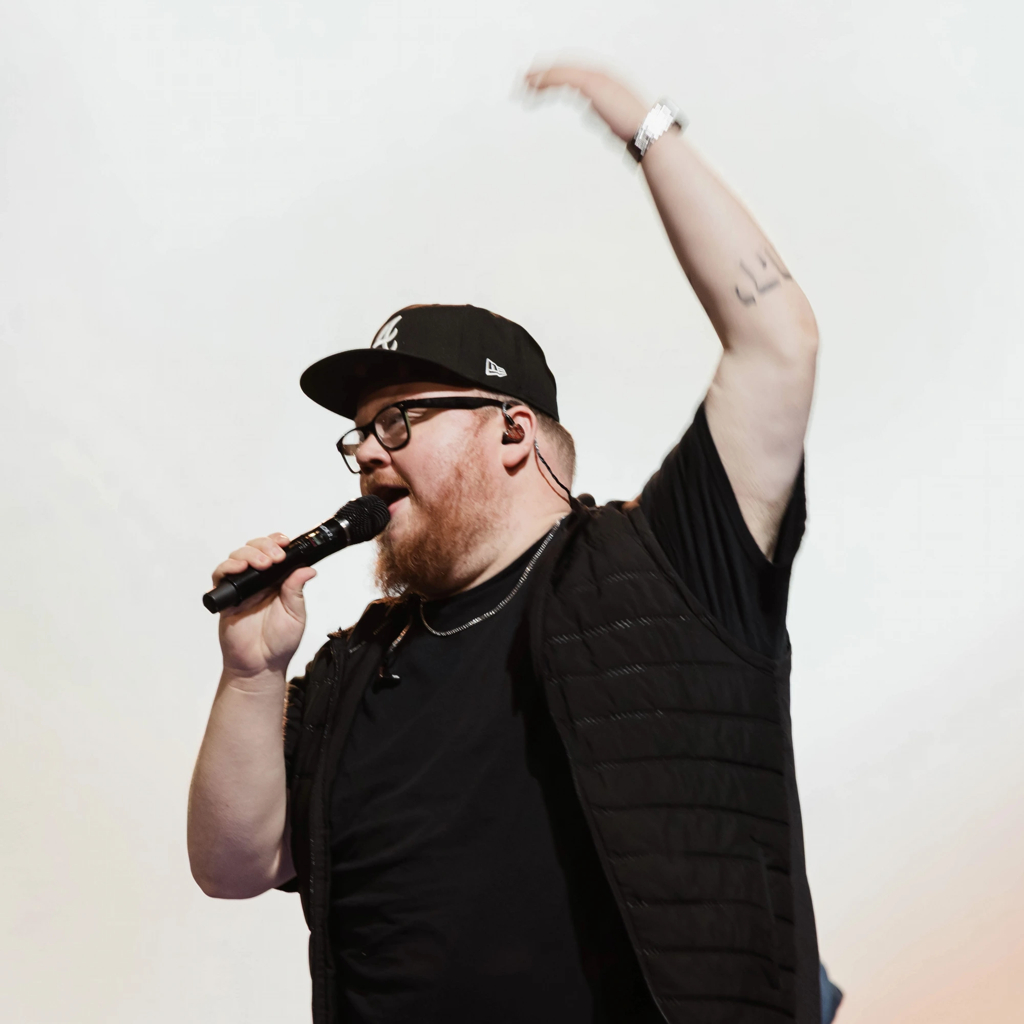 David Rosenblum leading worship with one arm raised